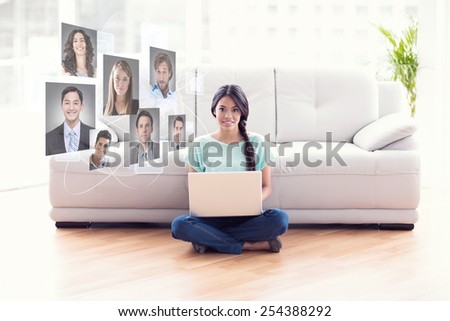 Pretty girl sitting on floor using laptop smiling at camera against profile pictures