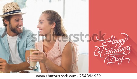 Happy couple enjoying coffee and cake against happy valentines day