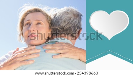 Senior woman hugging her partner against heart label