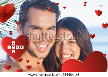 Cheerful loving couple having holidays against love you tiles