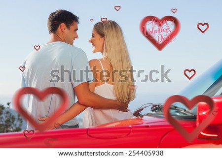 Rear view of cute couple hugging against happy valentines day