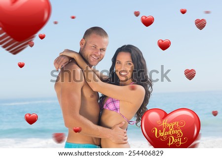 Attractive young couple hugging each other against happy valentines day