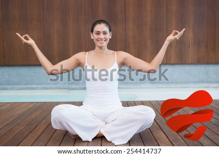 Peaceful happy woman in white sitting in lotus pose against heart