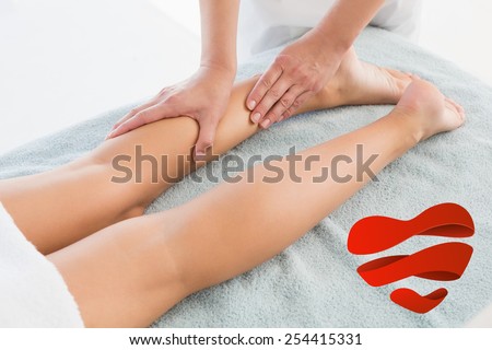 Woman receiving leg massage at spa center against heart