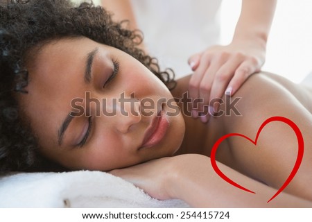 Gorgeous woman enjoying a shoulder massage against heart