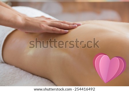 Woman enjoying a back massage against heart