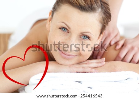 Charming woman enjoying a back massage against heart