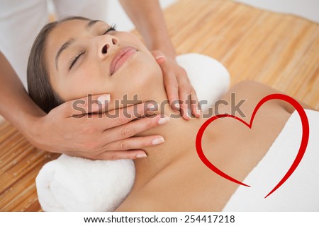 Beautiful brunette enjoying a head massage against heart