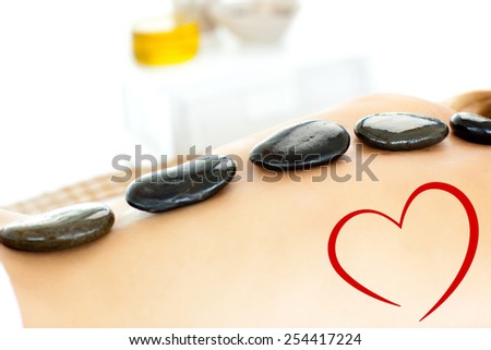 Close up of a beautiful woman having a massage against heart