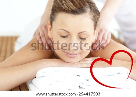 Relaxed woman enjoying a back massage against heart