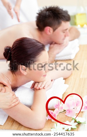 Attractive young couple enjoying a back massage against heart