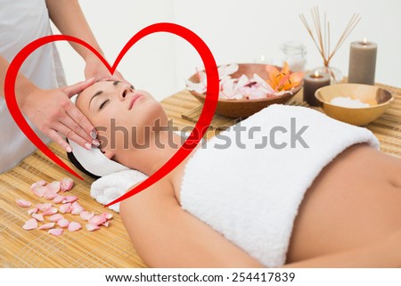 Peaceful brunette enjoying a head massage against heart