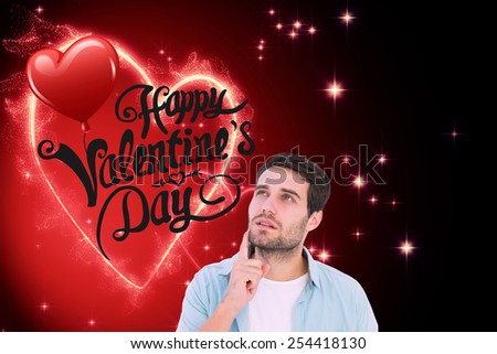 Happy casual man thinking with hand on chin against valentines heart design