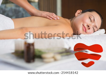 Content brunette getting a back massage against heart