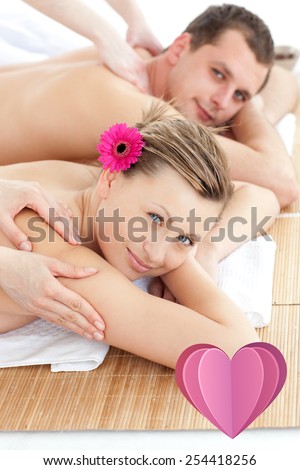 Attractive young couple receiving a back massage against heart