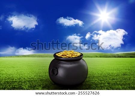 pot of gold against sunny green landscape