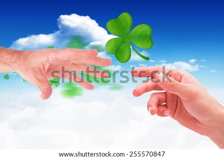 Businessman holding his hand out against bright blue sky with clouds