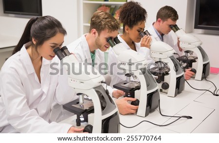 Medical students working with microscope at the university