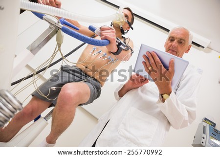 Man doing fitness test on exercise bike at the medical centre