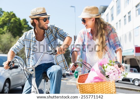 Attractive couple on a bike ride on a sunny day in the city