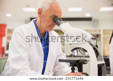 Medical professor working with microscope at the university