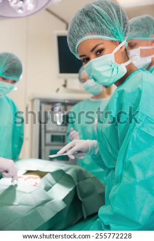Medical student looking at camera during practice surgery at the university