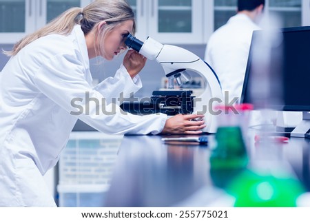 Science student working with microscope in the lab at the university