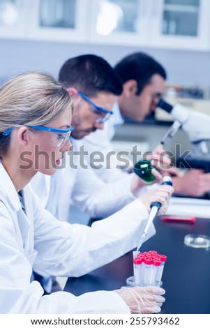 Science students working with chemicals in lab at the university