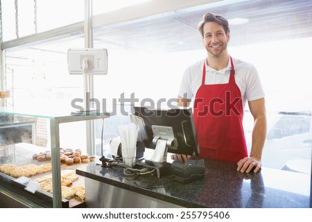 Casual server posing behind the counter at the bakery