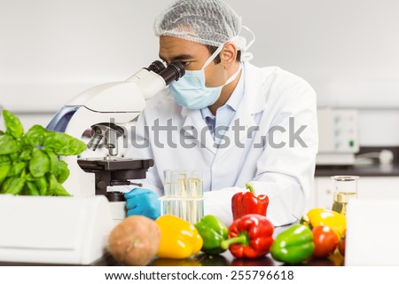 Food scientist using the microscope at the university