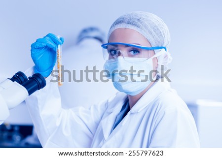 Food scientist holding test tube of corn at the university