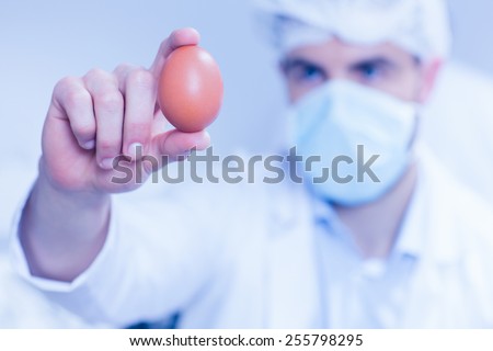 Food scientist looking at an egg at the university