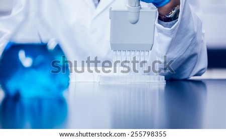 Science student using electronic pipette at the university