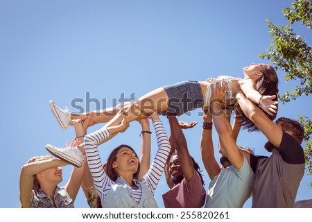 Pretty brunette crowd surfing on a sunny day