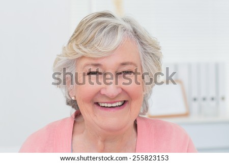 Portrait of happy female patient in clinic