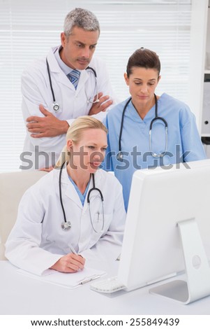 Doctors looking at computer in medical office