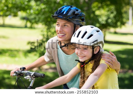 Mother and daughter on their bike on a sunny day