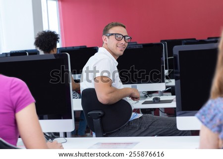 Male student smiling at camera in computer class