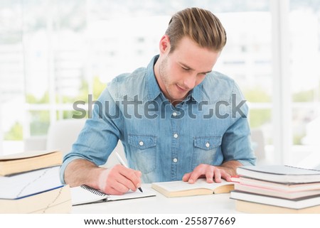 Casual businessman studying at his desk in his office