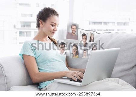Happy woman sitting on couch using her laptop against profile pictures