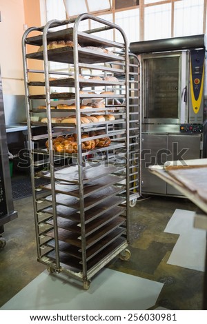 Catering building with shelf of fresh breads in the kitchen of the bakery