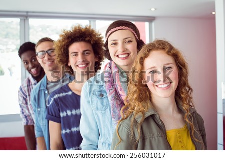 Fashion students smiling in a single line at the college
