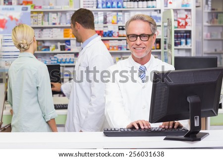 Happy pharmacist looking at camera at the hospital pharmacy