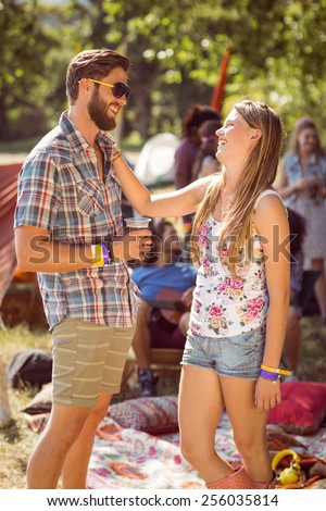 Hipster friends chatting on campsite at a music festival