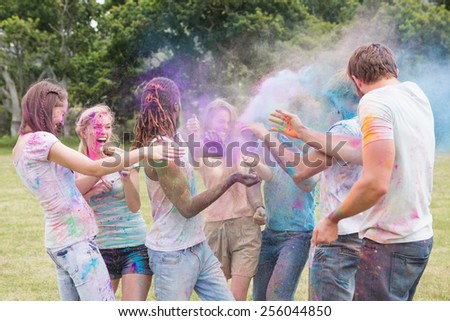 Friends having fun with powder paint on a sunny day