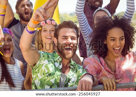 Excited young people singing along at a music festival