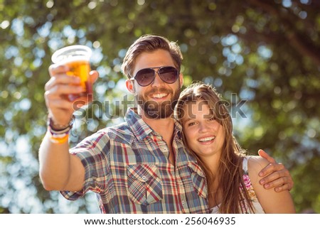 Hipster couple smiling at camera at a music festival