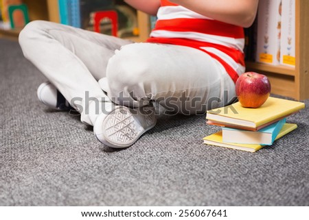 Student sitting on floor in library at the university