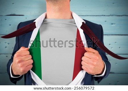 Businessman opening shirt to reveal italy flag against painted blue wooden planks