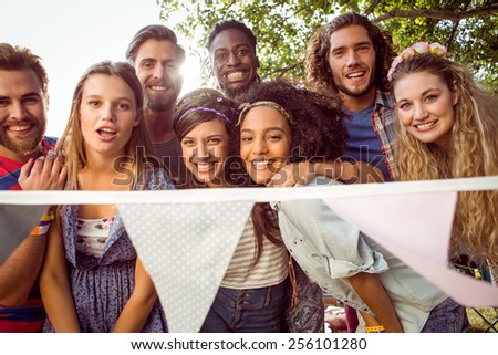 Happy hipsters smiling at camera at a music festival
